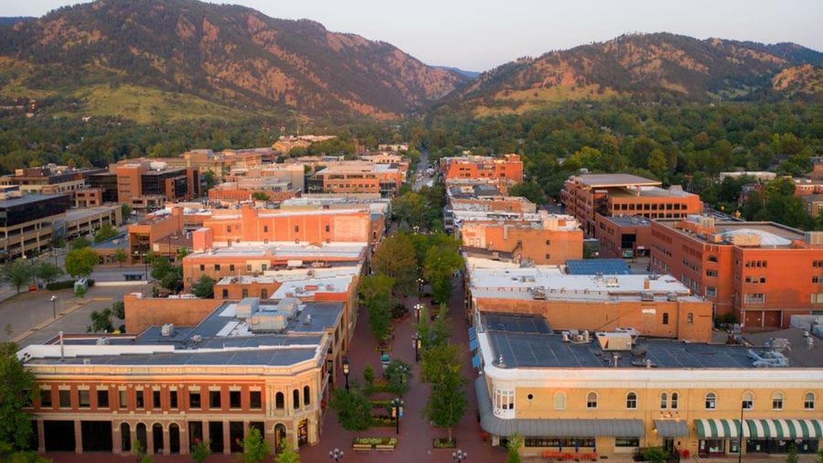 Aerial view of the Pearl Street Mall in downtown Boulder, Colorado with the Flatirons behind