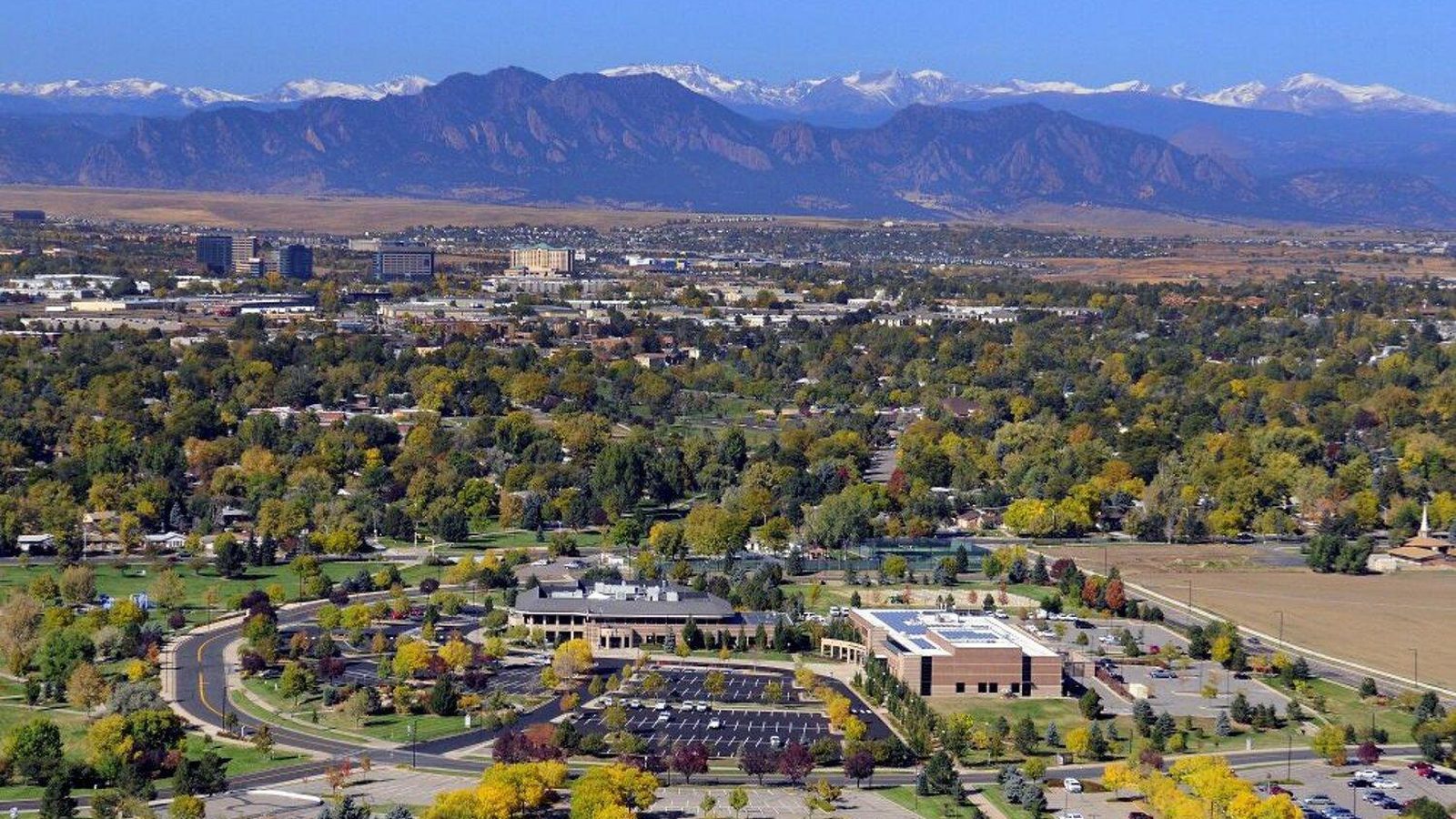 Aerial view of Broomfield, Colorado with the Flatirons and snow-capped Front Range in the distance