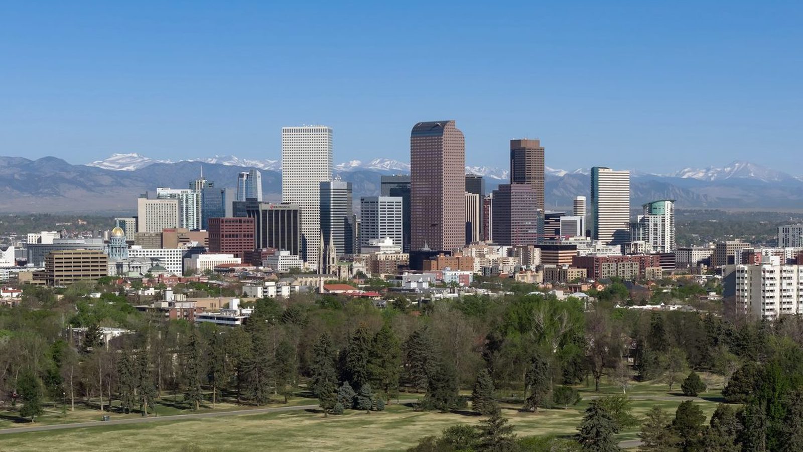 The downtown Denver skyline with the Front Range behind it
