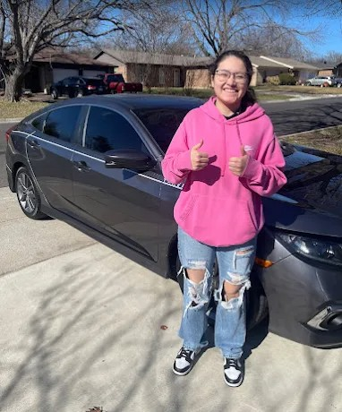 Colorado Dent Solutions customer giving two thumbs up beside their repaired grey vehicle