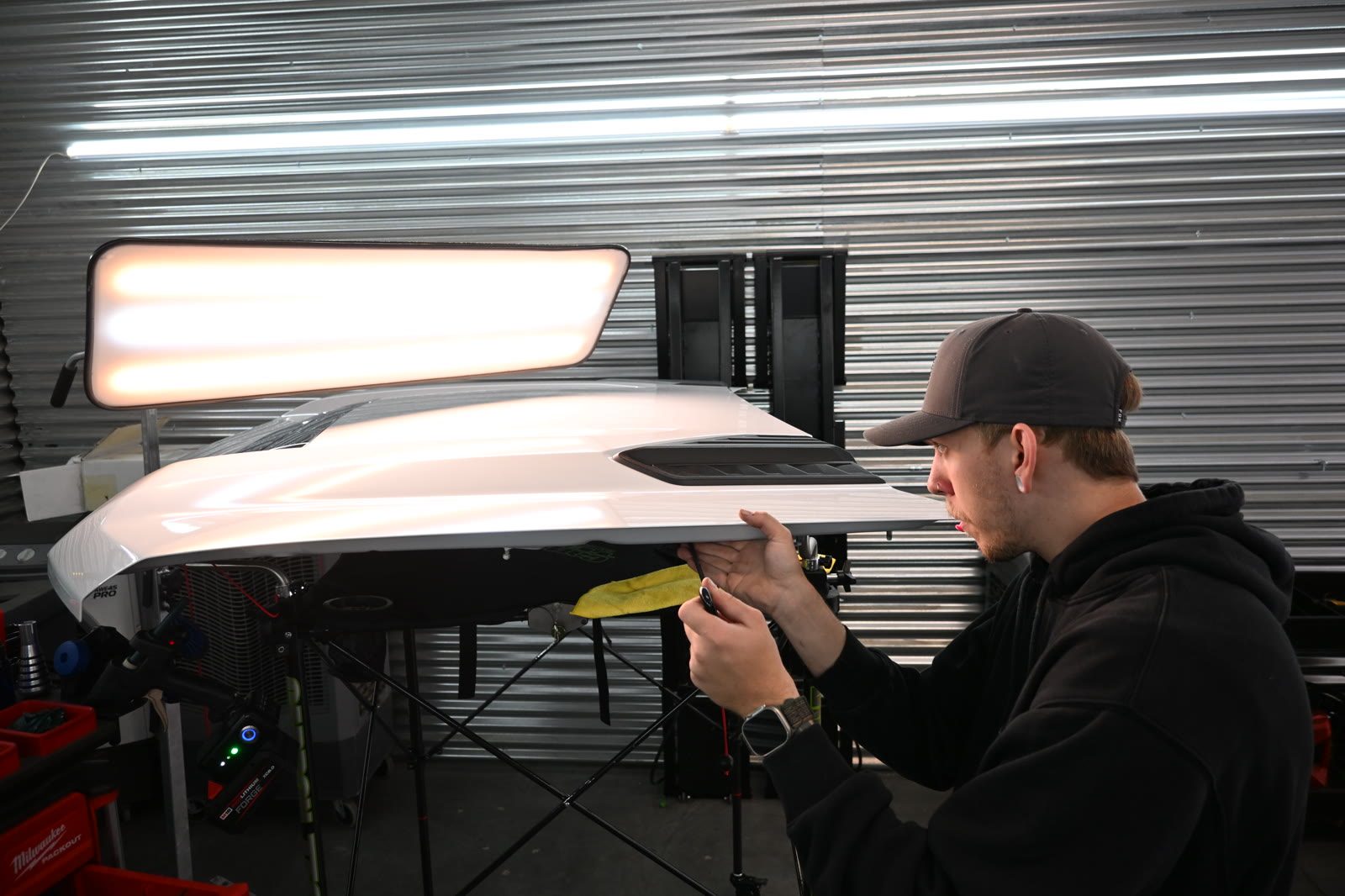 Colorado Dent Solutions technician working a dent out of a vehicle panel from behind the metal
